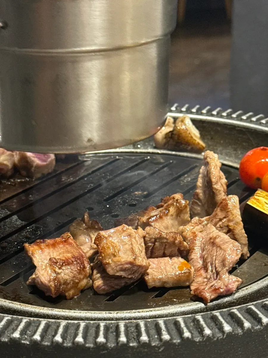 Grilled meat resting on the brazier