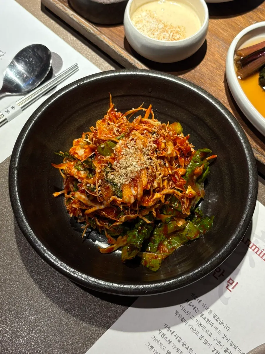 Side dishes including geotjeori, pickled vegetables, ssamjang, and breadcrumb sauce