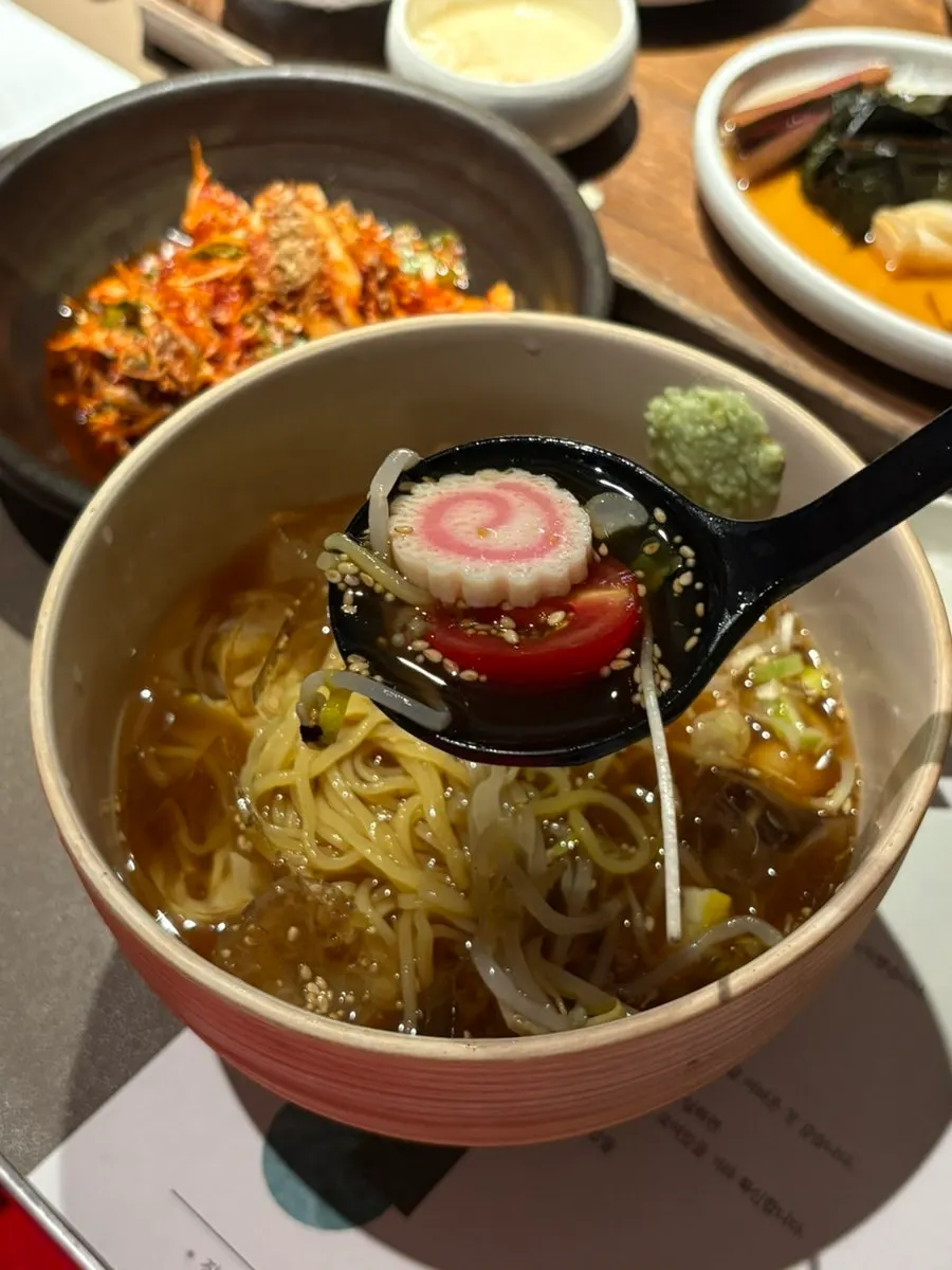 Cold ramen noodles topped with bean sprouts in anchovy broth