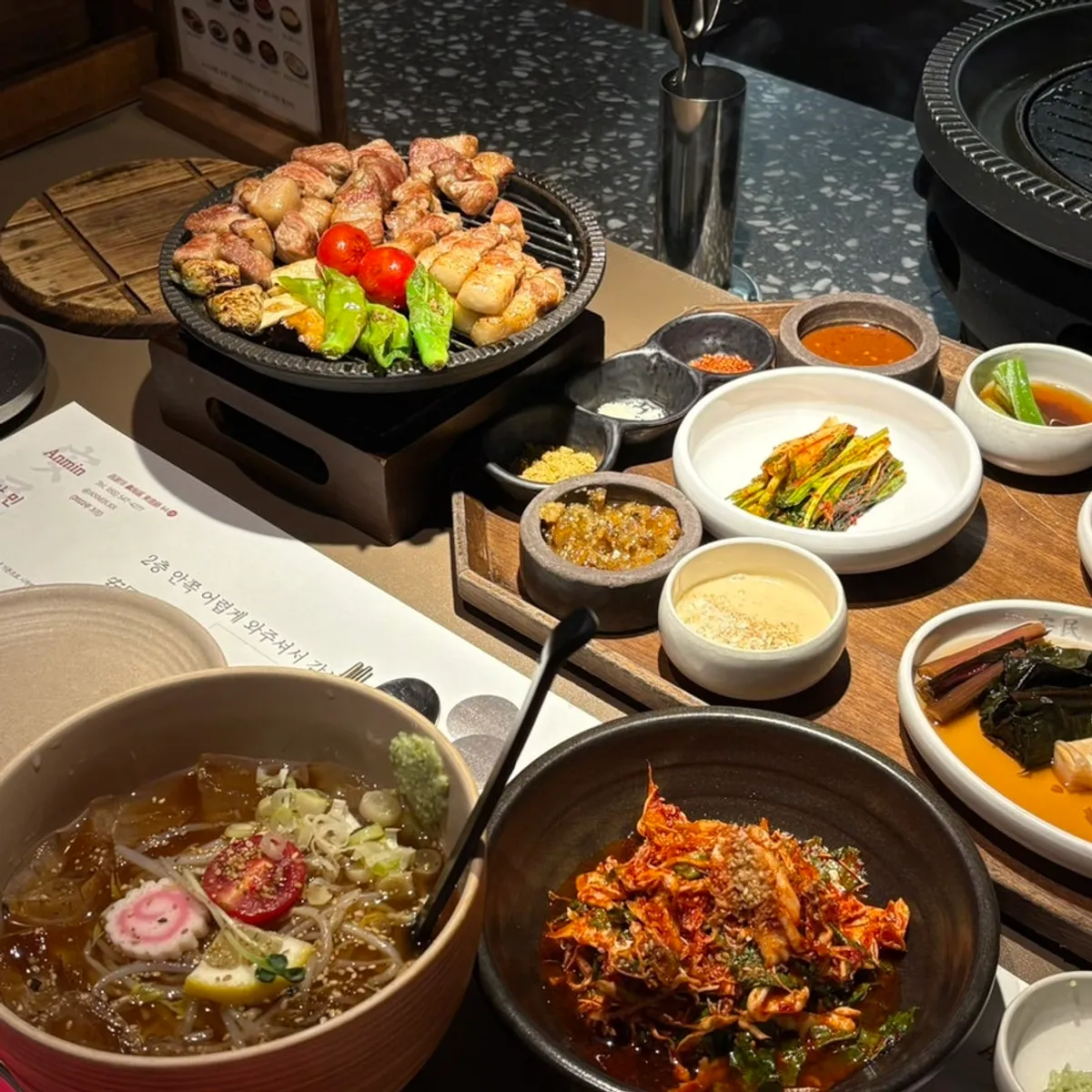 Table spread of meat and side dishes at Anmin Jinhae