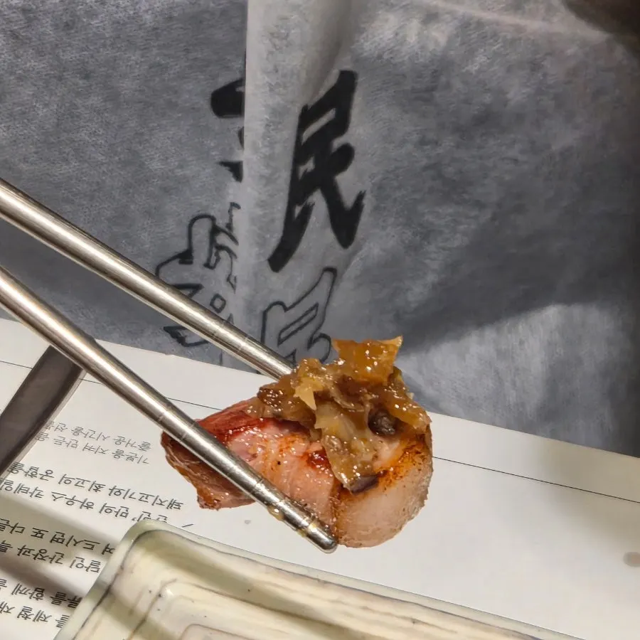 A piece of pork paired with barley ssamjang