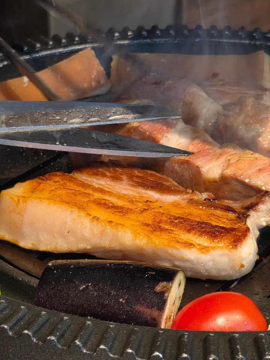 Meat turning golden brown on the grill