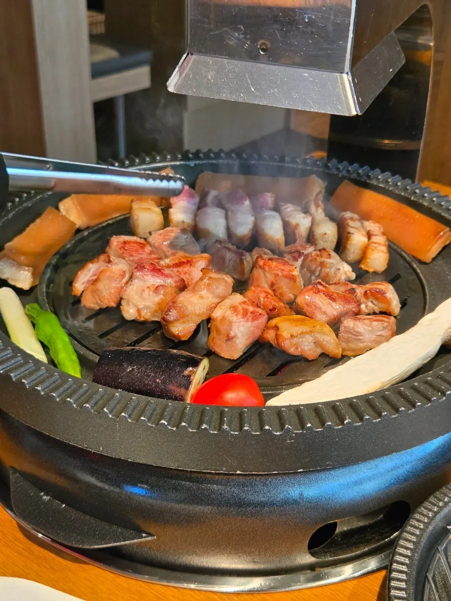 Close-up of pork belly well grilled over charcoal