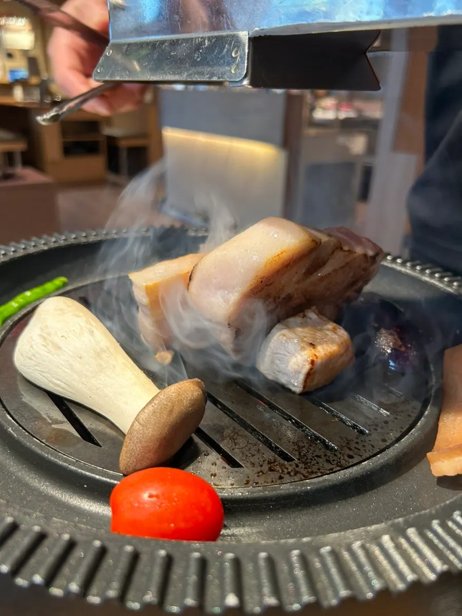 Staff placing meat on the grill