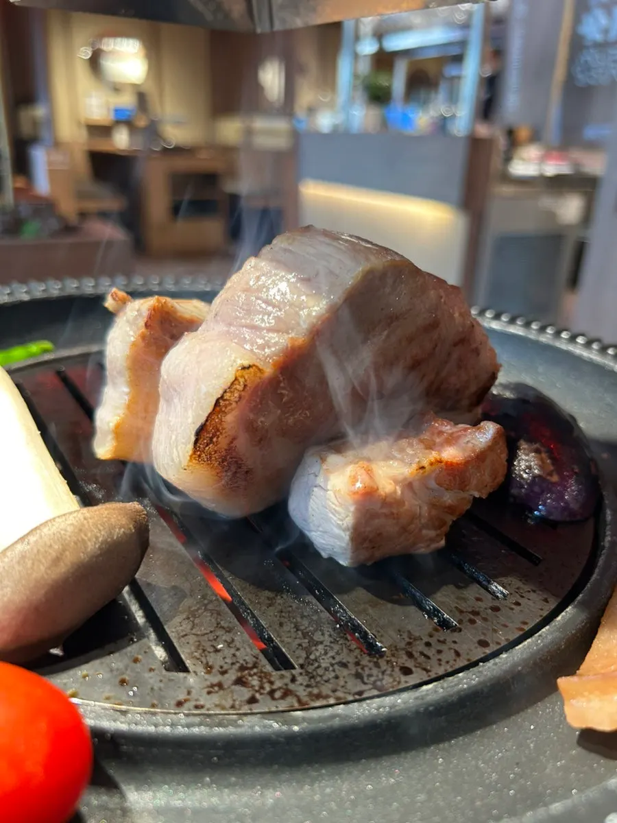 Pork belly grilling on the fire