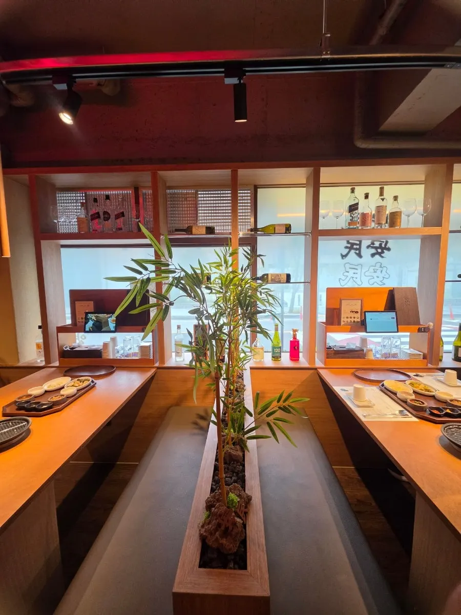 Small shelf of tableware next to a table at Anmin Yangsan