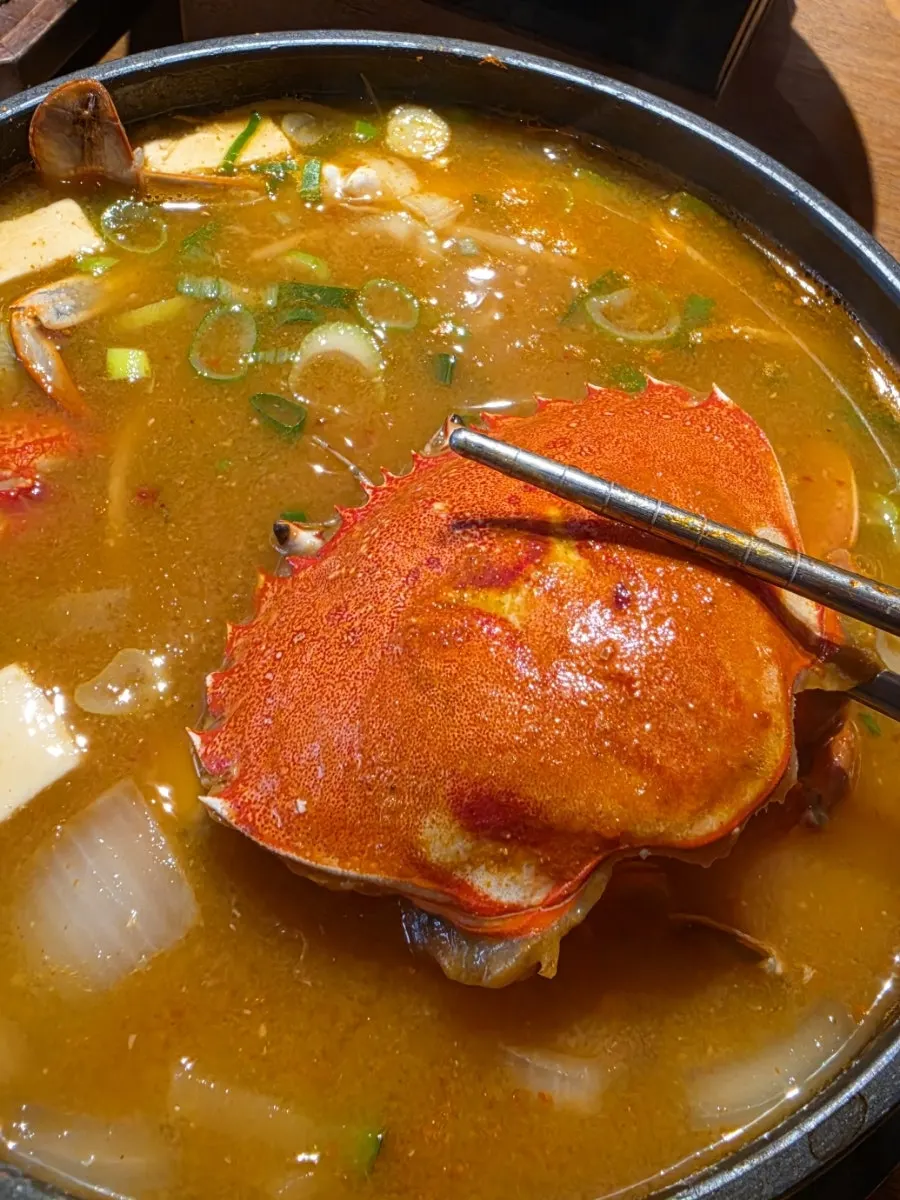 Broth from the hwang doenjang jjigae with river snails and dough soup