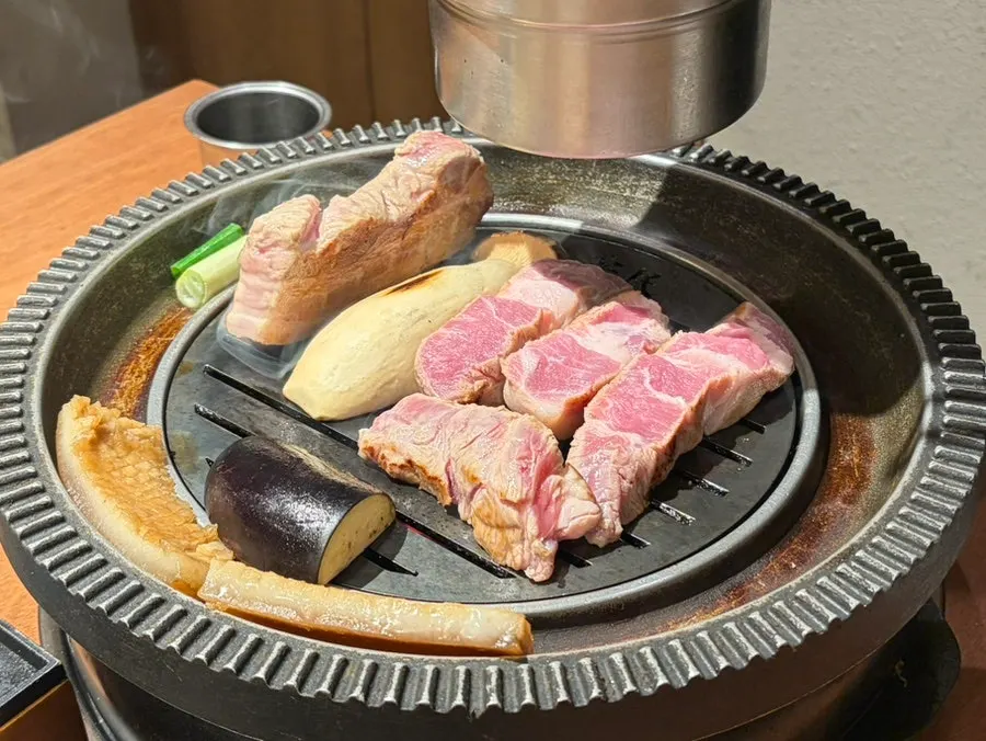 Staff grilling meat on the grill
