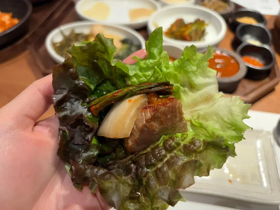 A piece of pork neck dipped in salt