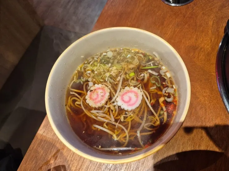 A piece of meat topped with shiitake wasabi sauce