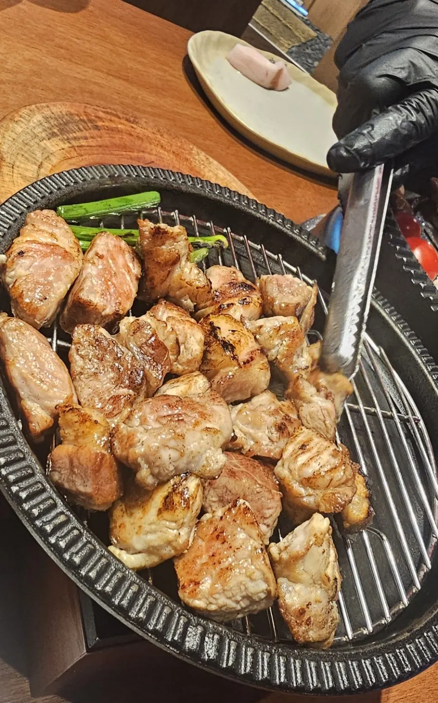 Small grill plate holding the meat grilled by staff