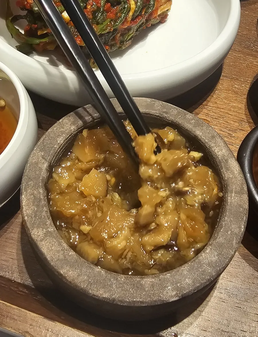 A piece of pork neck dipped in pine flower salt