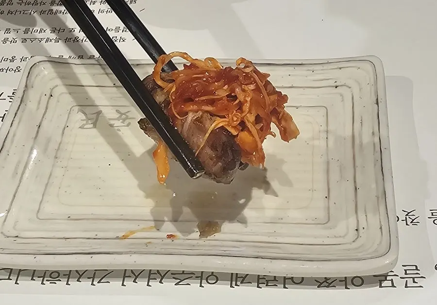 Pork neck dipped in cheese fondue sauce