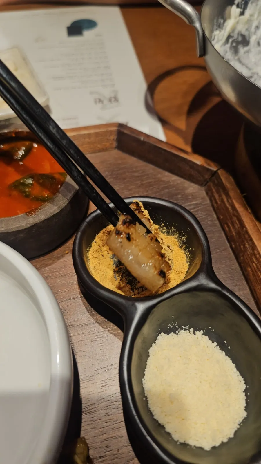 A piece of pork neck topped with shiitake wasabi