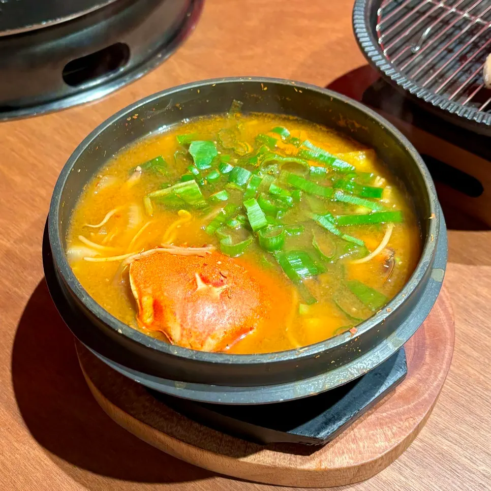 Golden doenjang stew with a whole crab inside