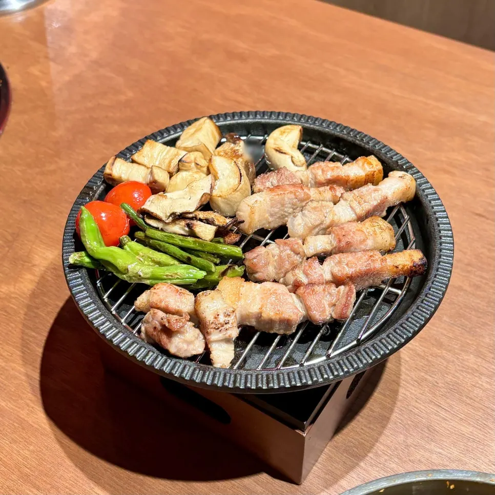 Grilled pork belly placed on a small brazier