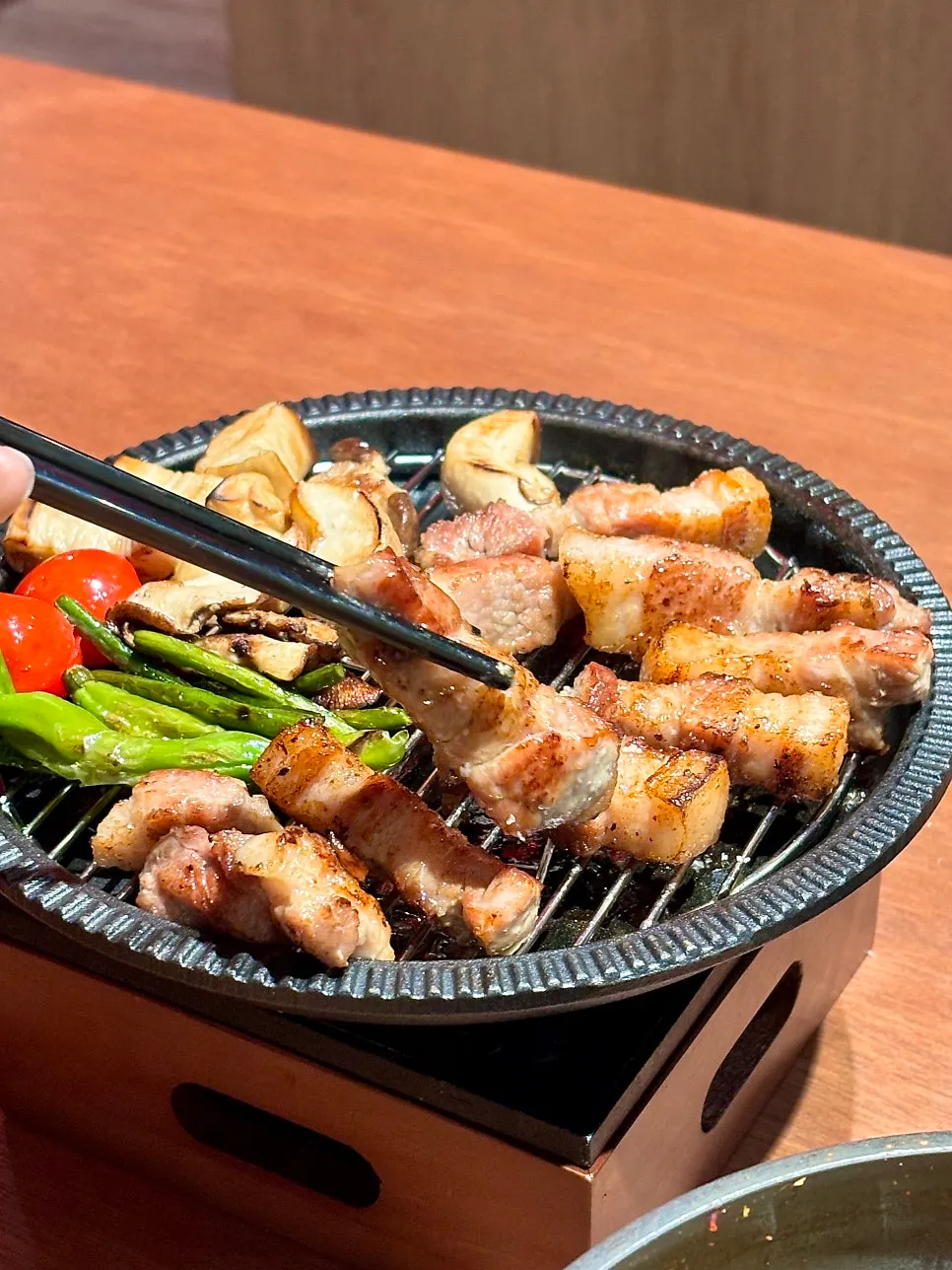 Mushrooms and garlic scapes grilled alongside the meat
