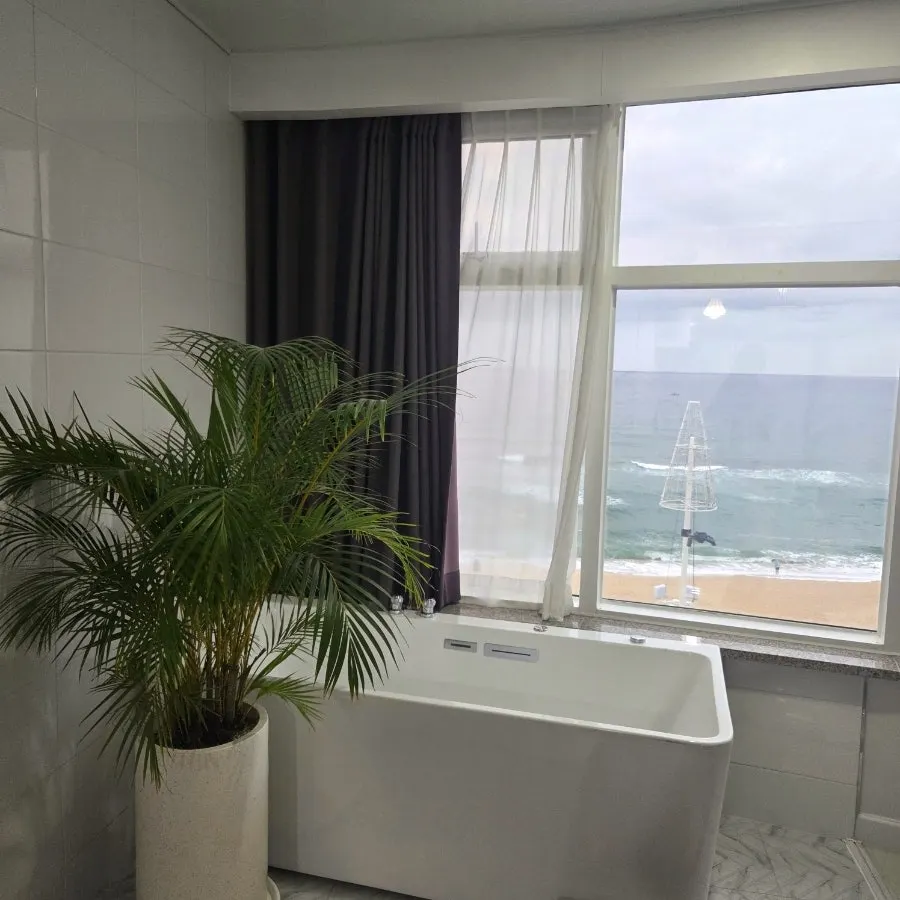 Spa tub and picture window facing the sea