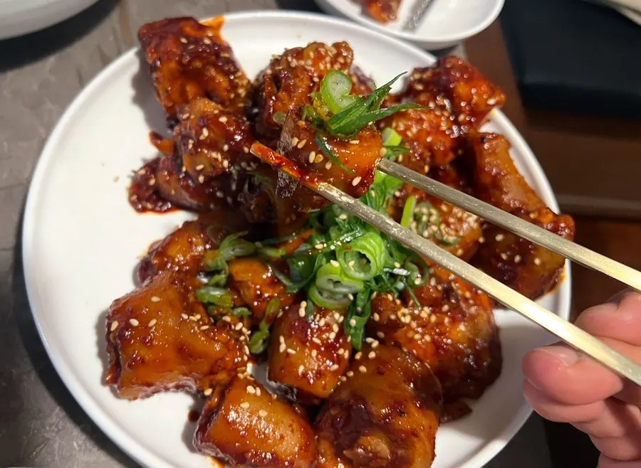 Pork tail jjim served alongside gomtang