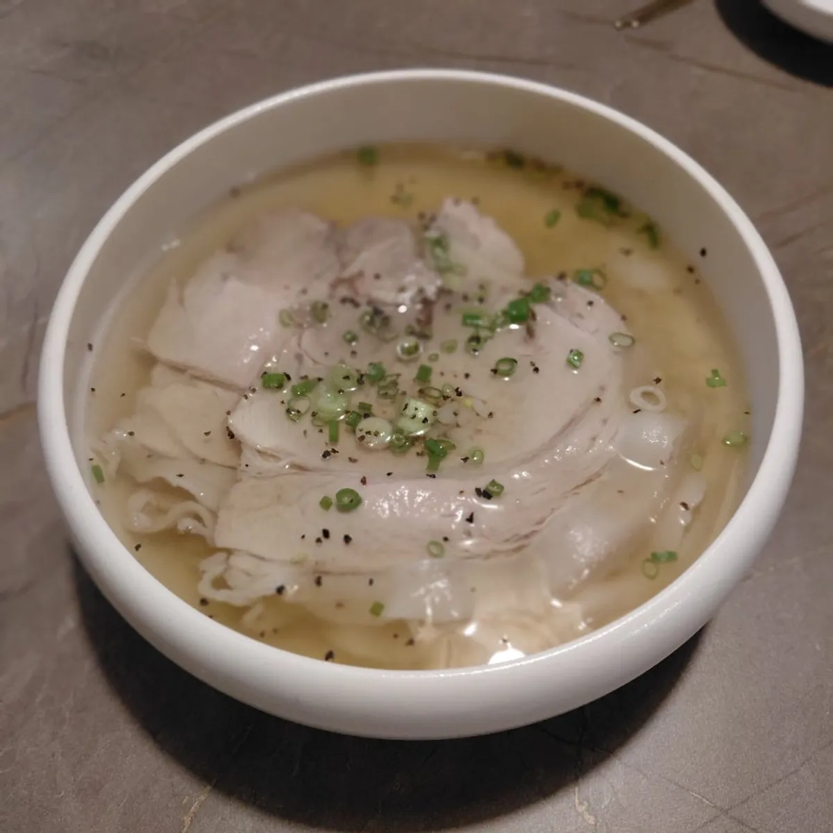 Table setting with clear pork gomtang and Pyeongyang naengmyeon at Anok
