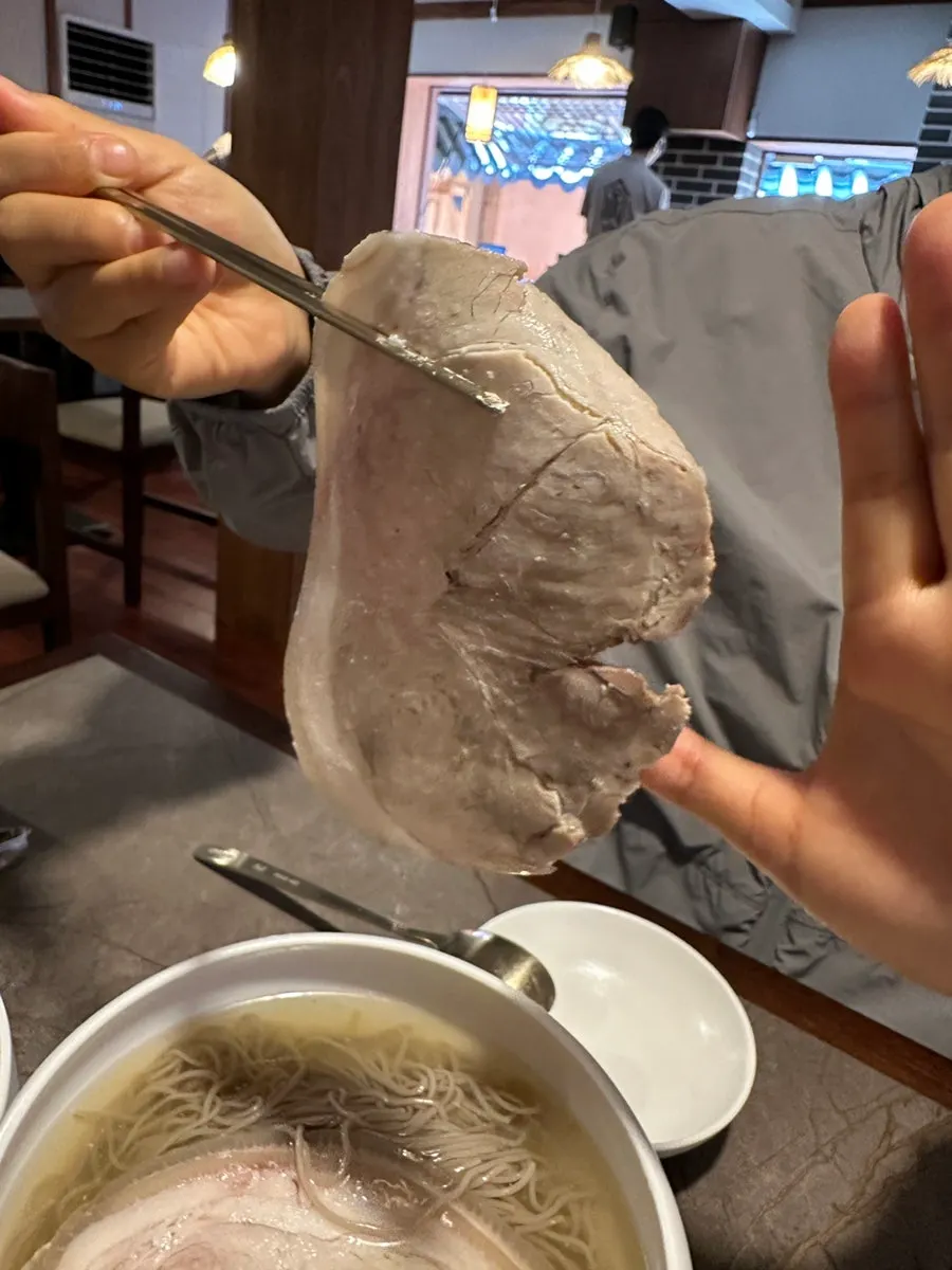 A thinly sliced piece of gomtang meat