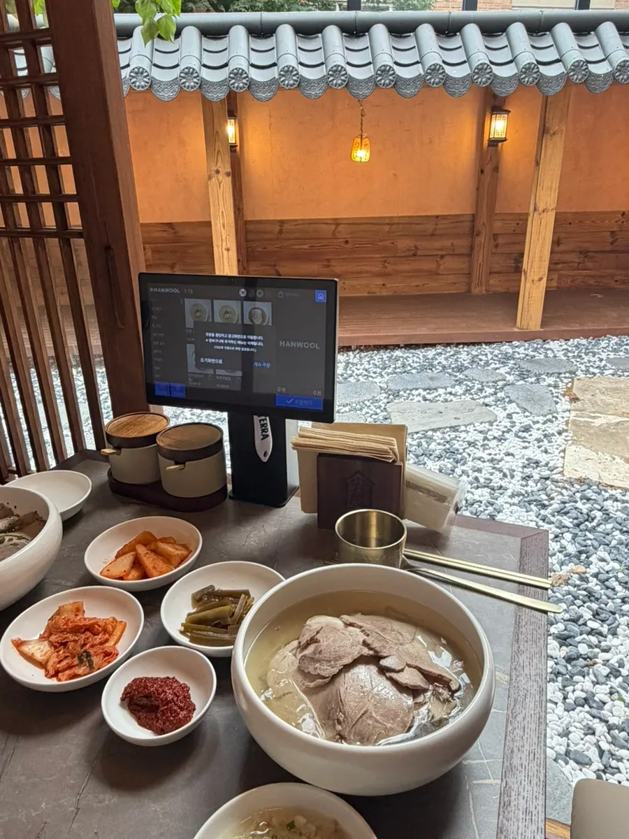 Vertical photo of Anok's gomtang and side dishes