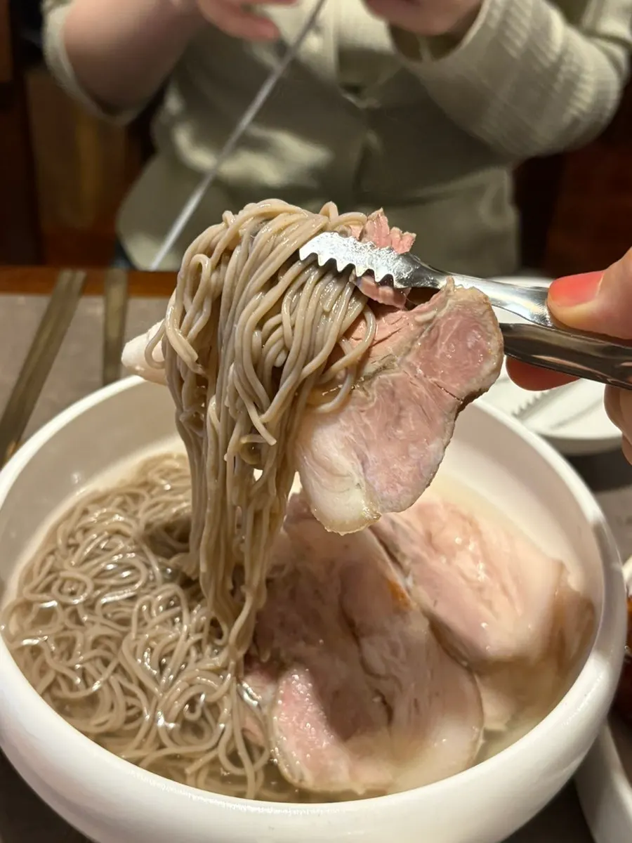 Thinly sliced boiled pork on top of bibim Pyongyang naengmyeon