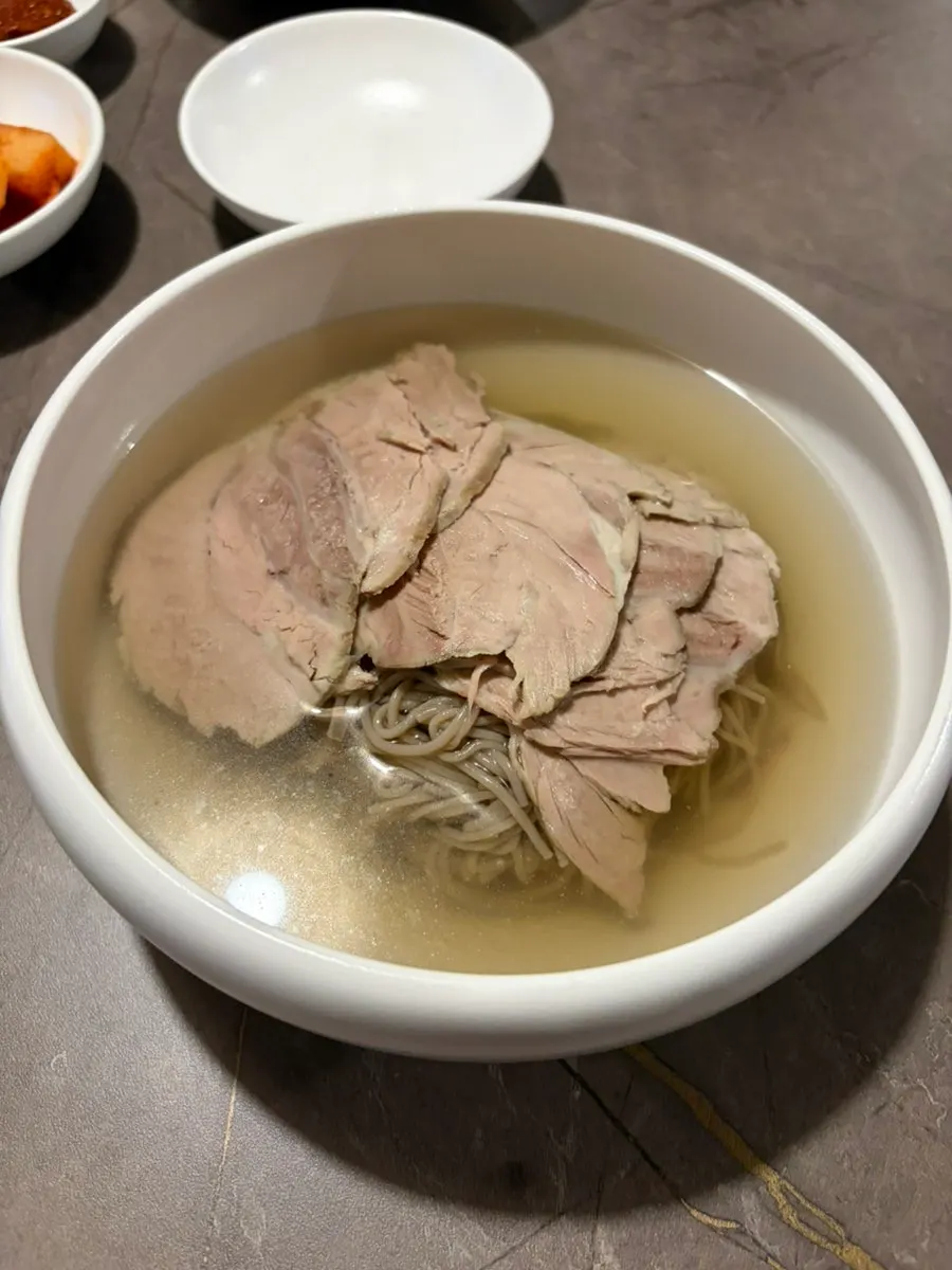 Anok's pork tail jjim topped with sesame seeds and scallions