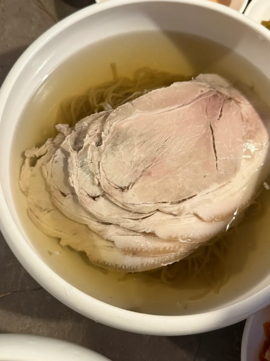Lifting up a hefty piece of meat from the gomtang