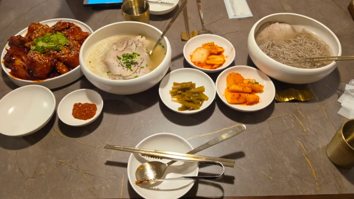 A table set with gomtang, Pyongyang naengmyeon, and ox tail together