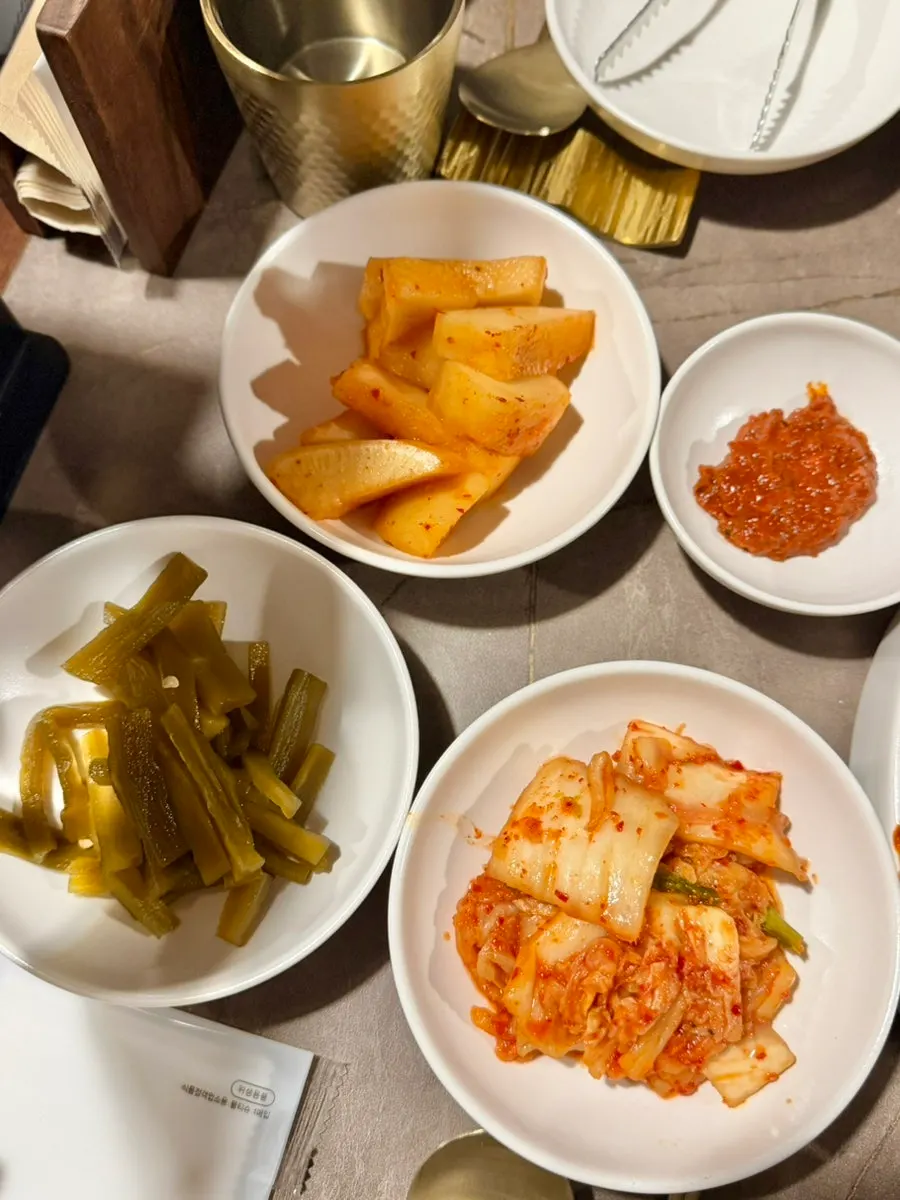 Side dishes including kimchi at Anok