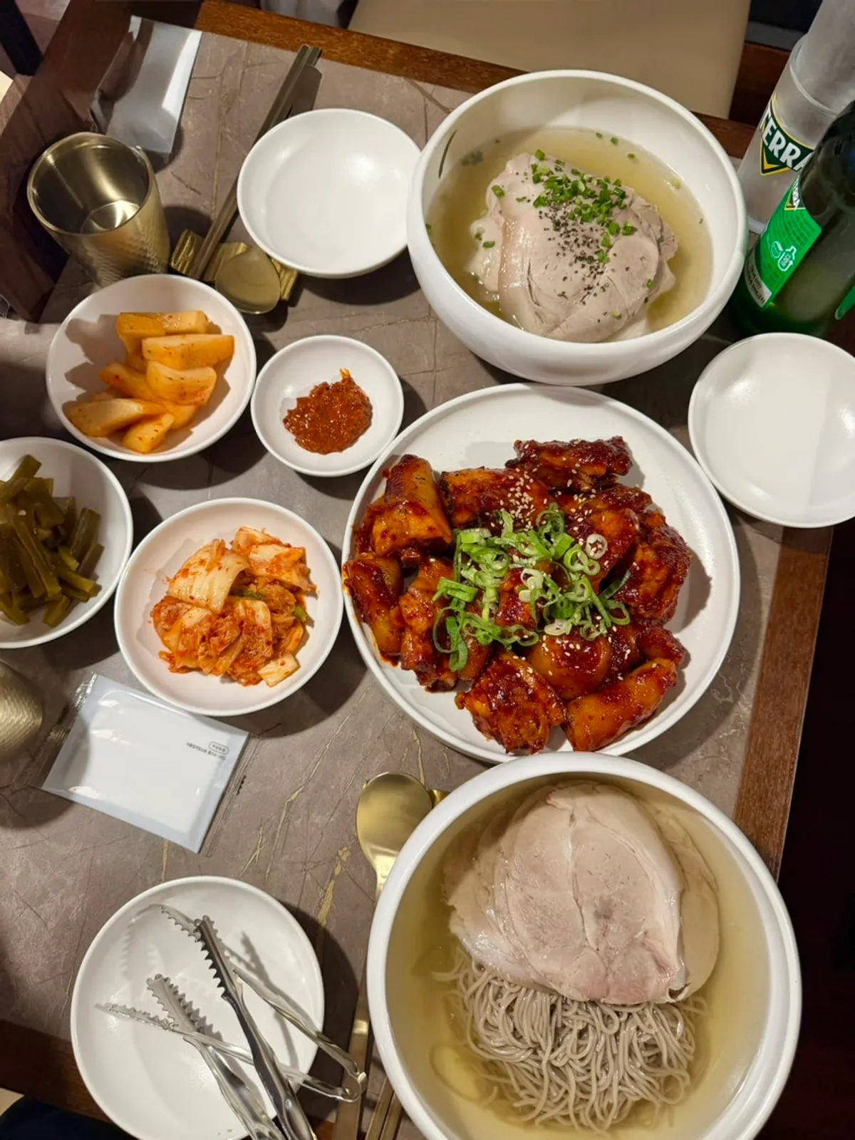 A bottle of beer served alongside the pork tail jjim