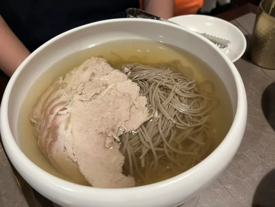 A spoonful of gomtang broth and meat