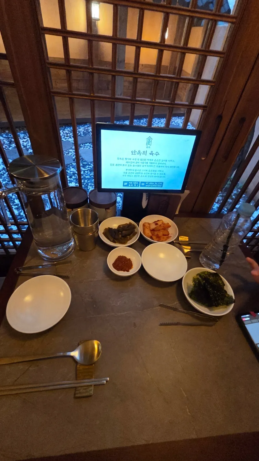 Self-serve bar with water cups and broth bowls