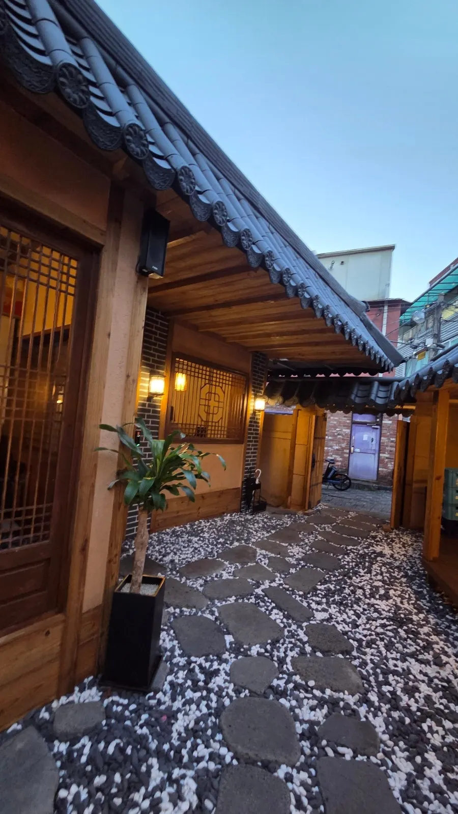 Evening view of Anok with lights on under the eaves