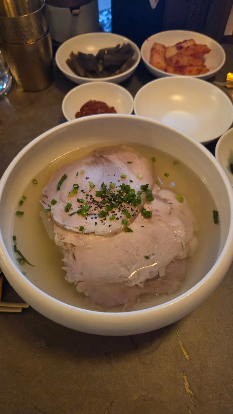 Spread of gomtang, naengmyeon, and braised pork tail