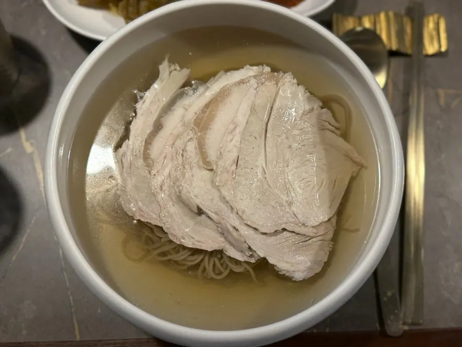 A spoonful of clear gomtang broth