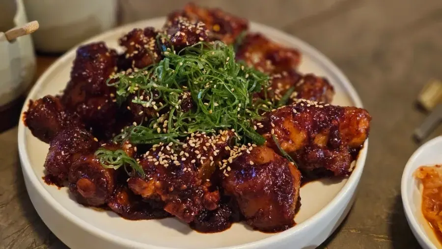 Pork tail jjim topped with shredded scallion and sesame seeds