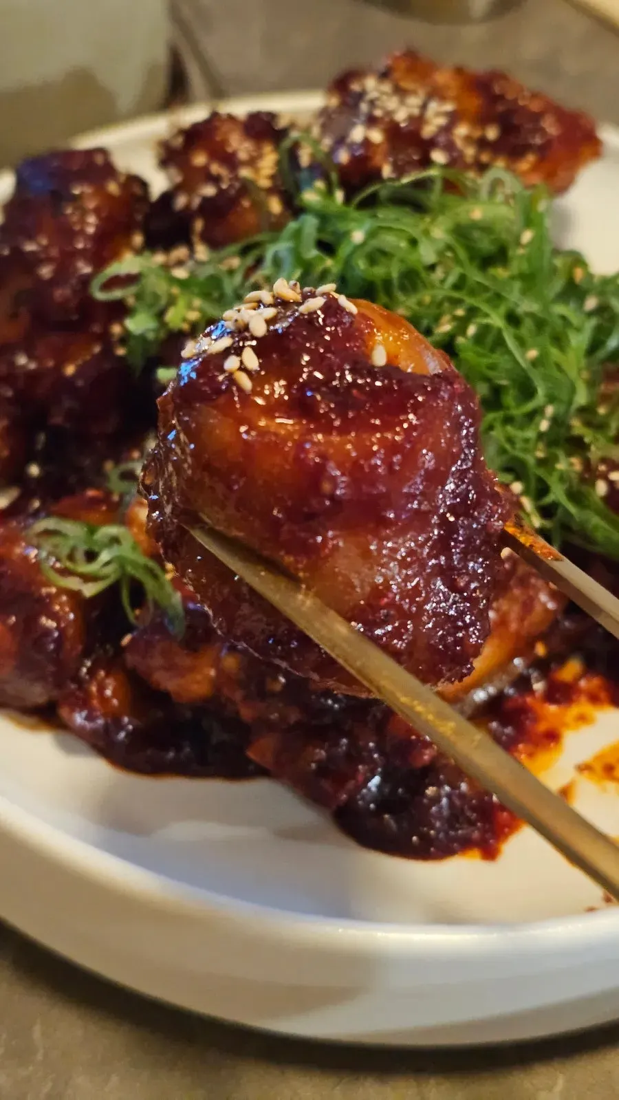 Pork tail jjim lifted with chopsticks