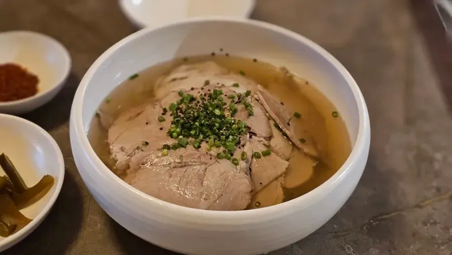 Clear pork gomtang topped with boiled pork slices