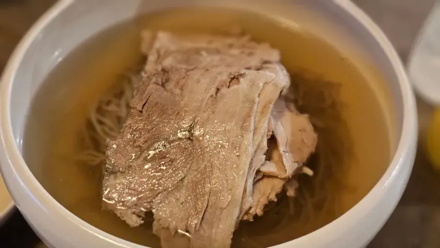Pyongyang naengmyeon with buckwheat noodles and thinly sliced boiled pork