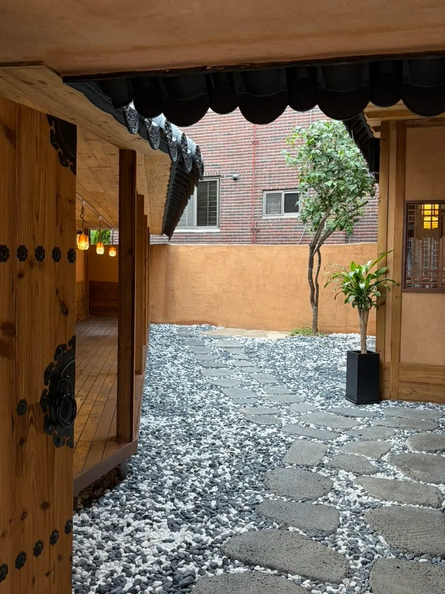 Anok's hanok entrance seen from the top of a staircase