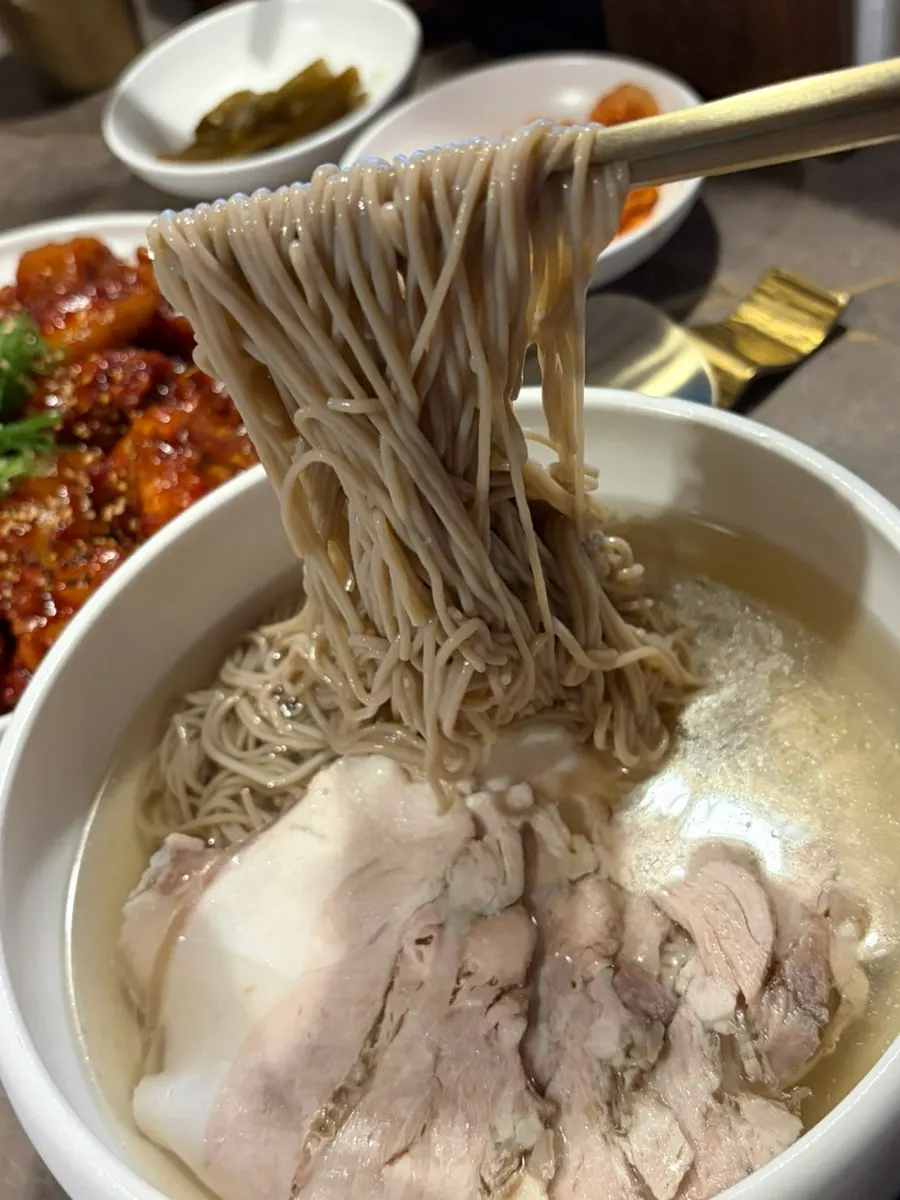 Pyongyang naengmyeon with noodles and toppings in clear broth
