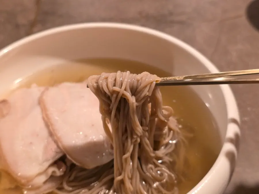 Close-up of naengmyeon broth and noodles