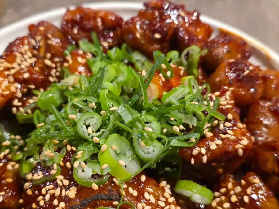 A piece of pork tail meat falling off the bone