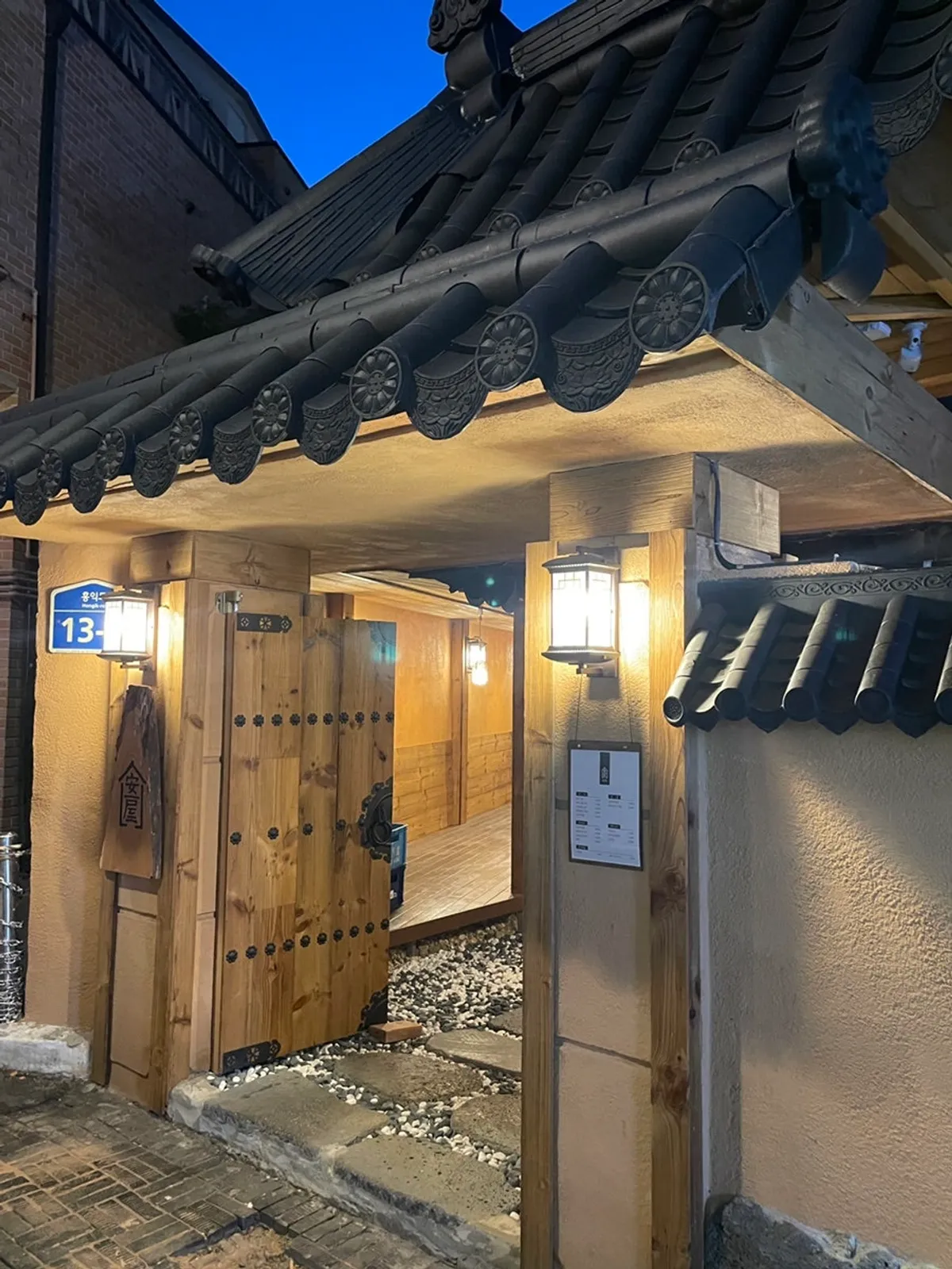 Anok's hanok exterior and entrance door lit up at night