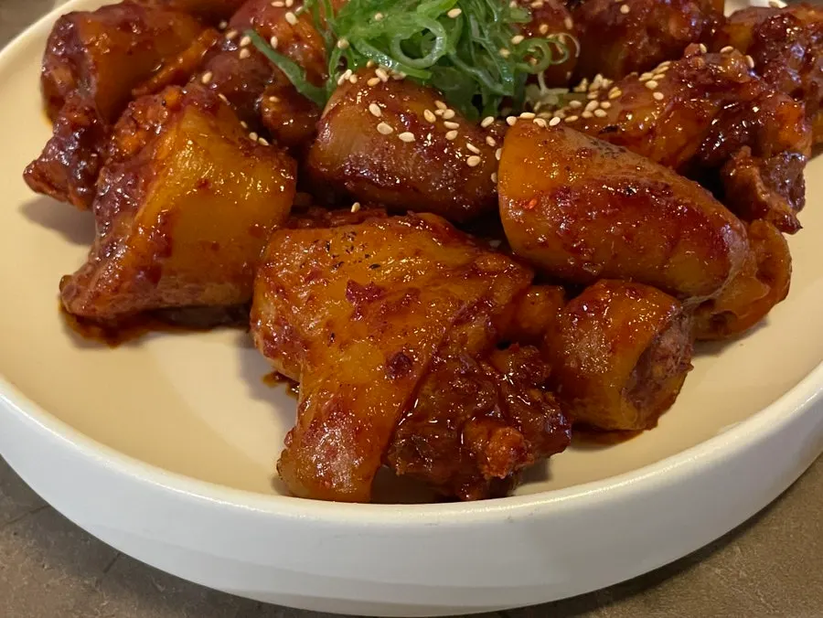 Hongdae pork tail jjim in a not-spicy sweet sauce and hanok lit at night, Anok