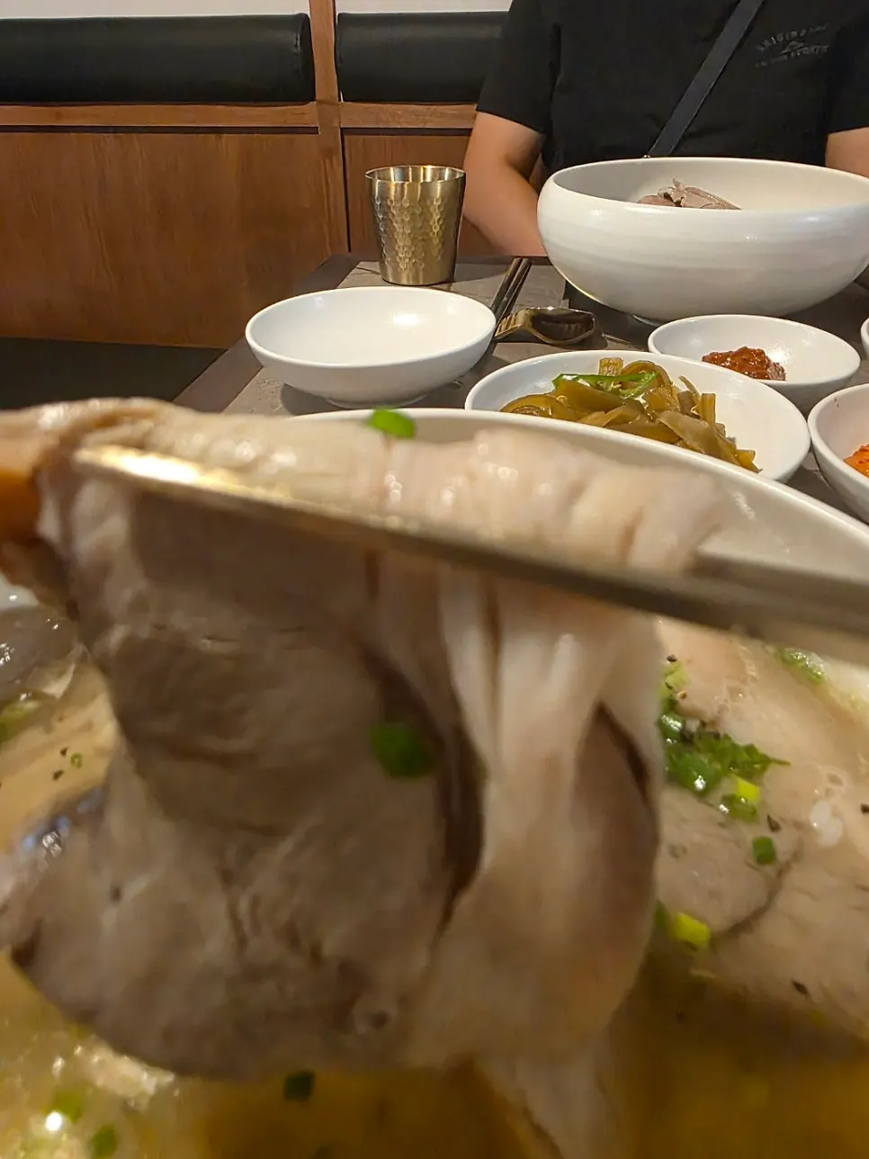 Noodles lifted with chopsticks from the naengmyeon bowl