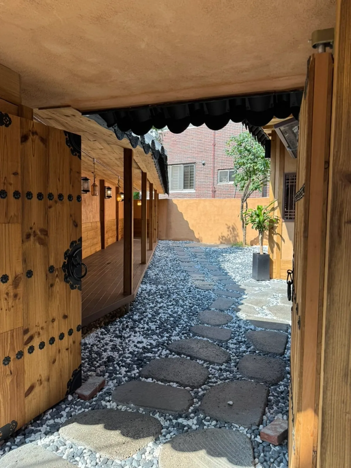 Sunlit hanok entrance of Anok