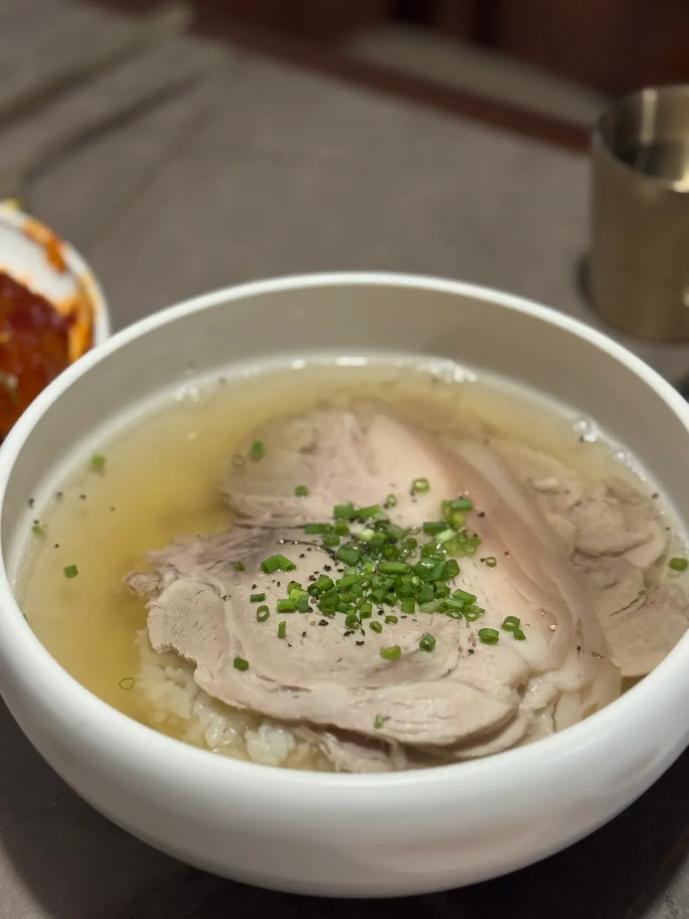 A bowl of Anok's clear gomtang topped with meat